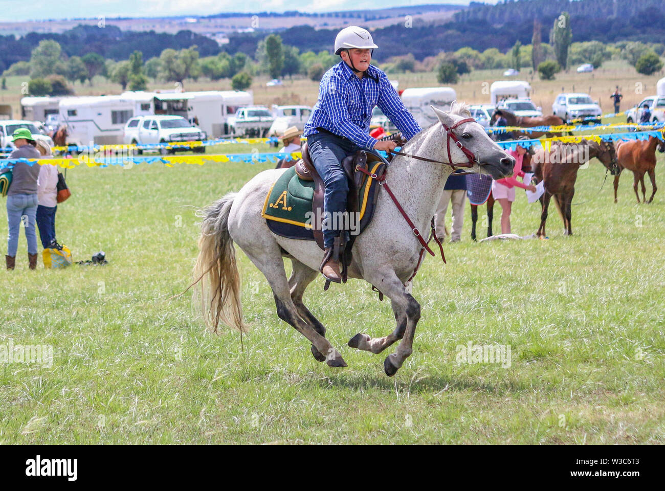Young man riding in barrel racing competition in country show, Bungendore, NSW, Australia Stock Photo