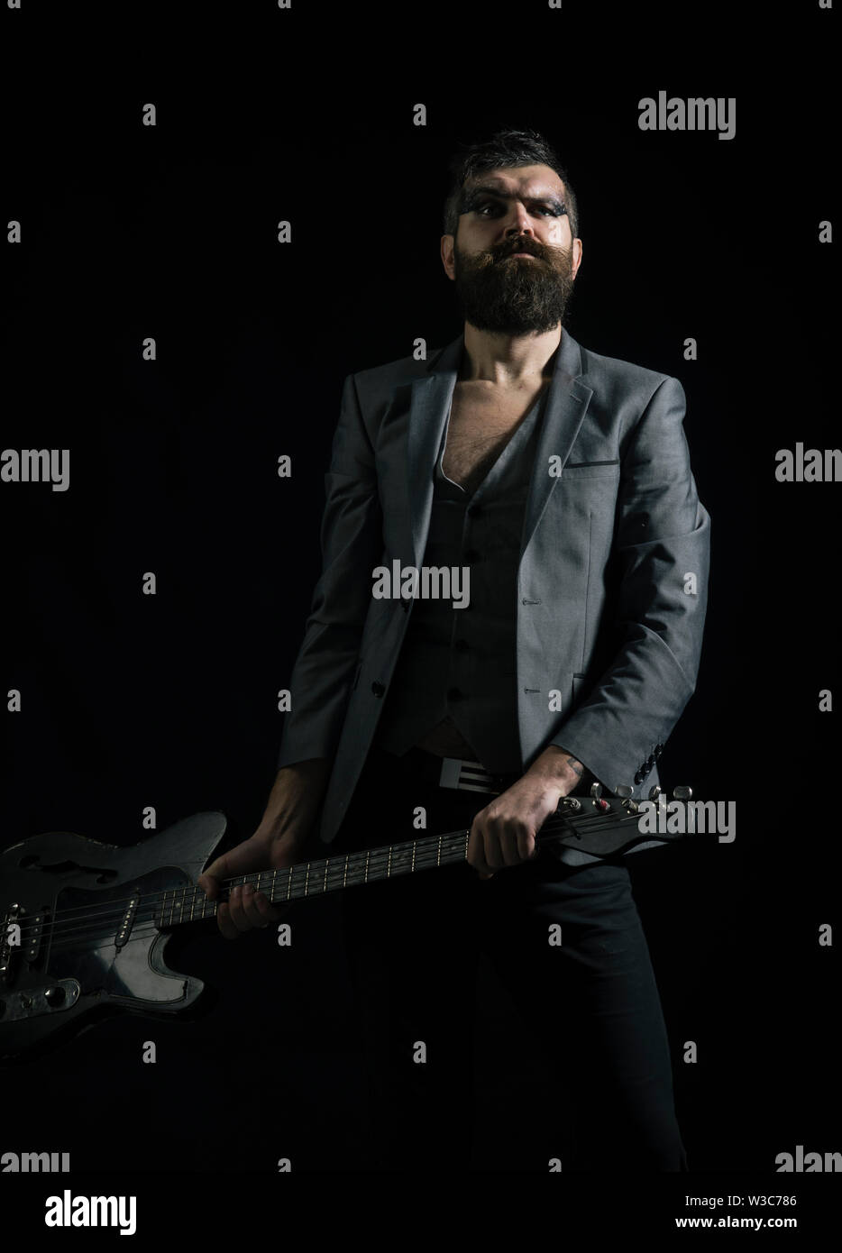 Musician or music player. Musician with electric guitar. Bearded musician with guitar. Rock