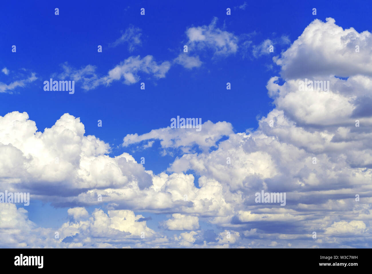 Fluffy cumulus clouds on blue sky Stock Photo - Alamy