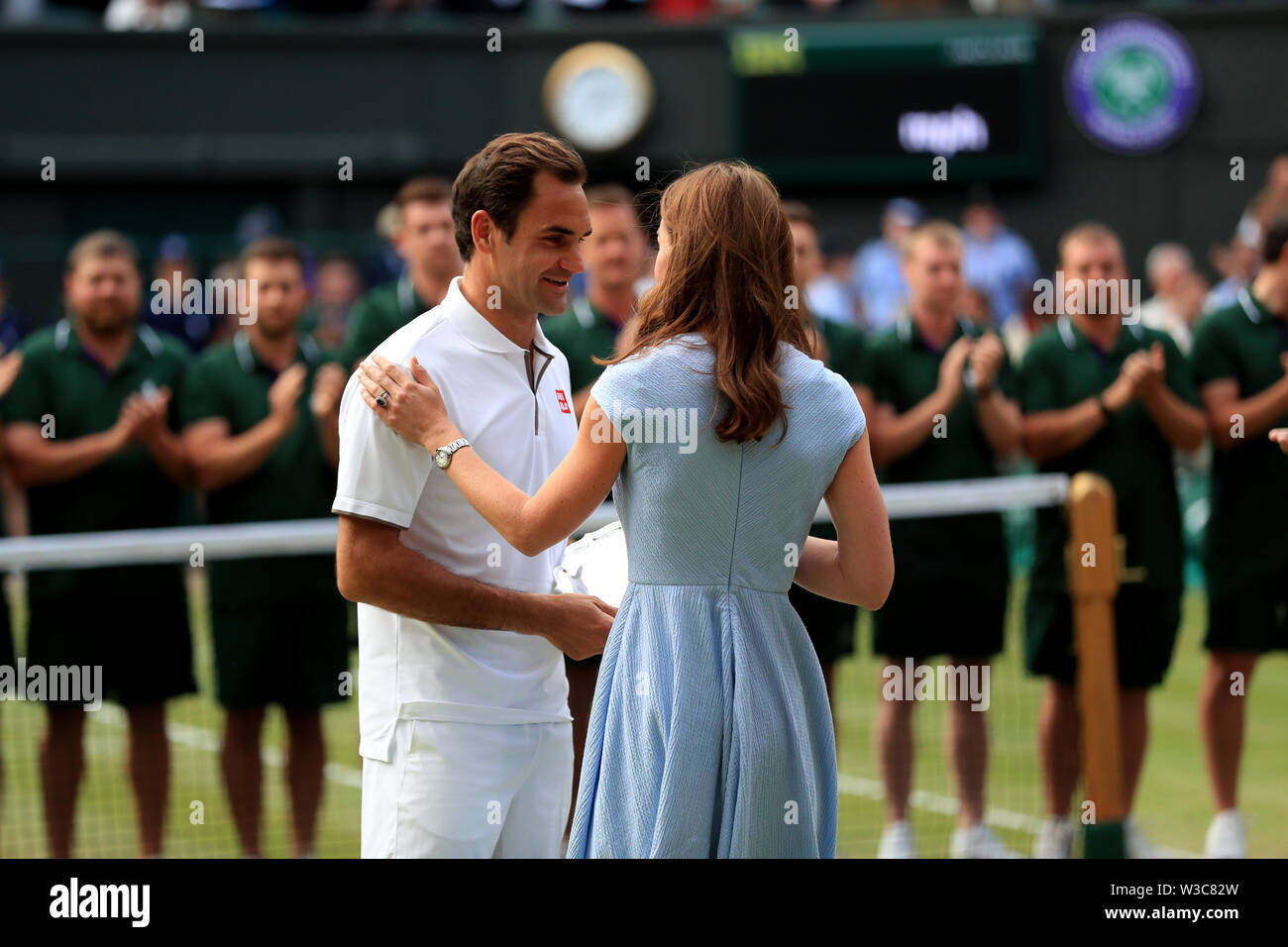 Roger Federer is presented the runners up trophy by the Duchess of  Cambridge after defeat to Novak Djokovic in the mens singles final on day  thirteen of the Wimbledon Championships at the