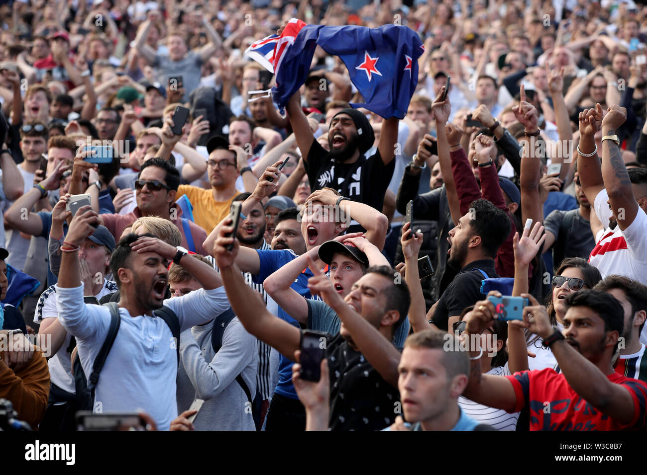 England and New Zealand fans react as they watch a big screen in the