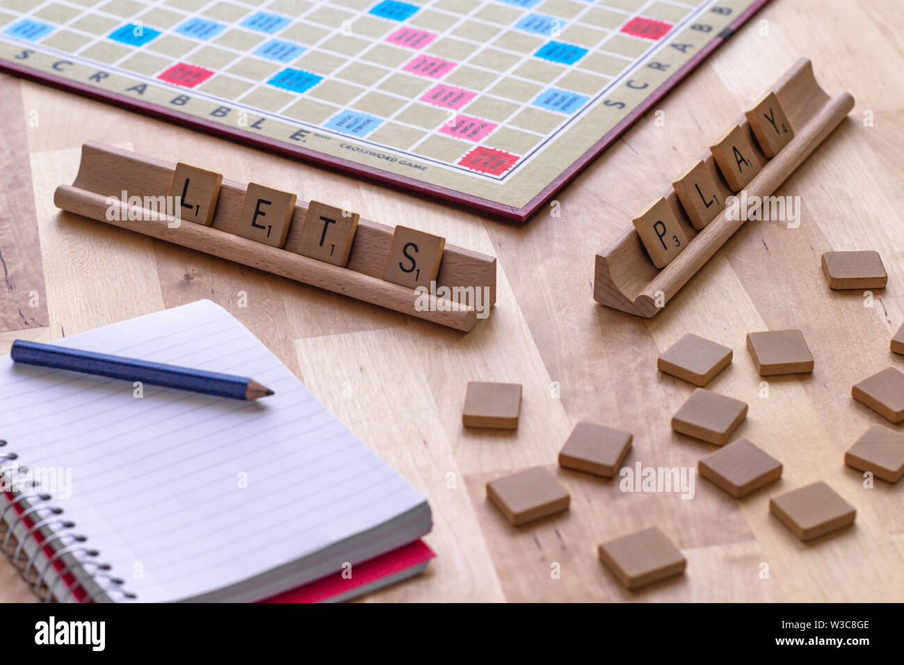 Scrabble board game with the scrabble tile spell "Lets Play" Stock Photo
