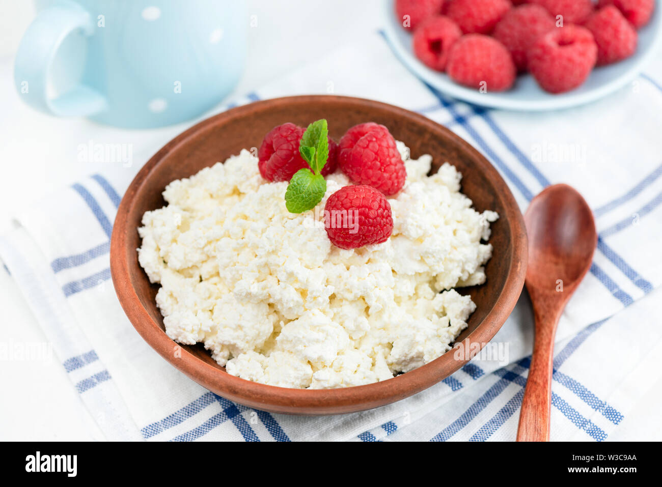 Cottage Cheese In Ceramic Bowl Decorated With Fresh Raspberries