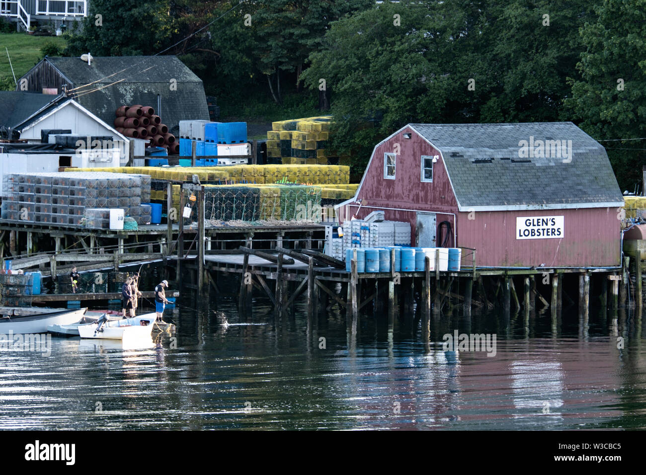Fisherman try their luck at Glens Lobster Wharf on Mackerel Cove, Bailey Island on a summers day in Harpswell, Maine. Stock Photo