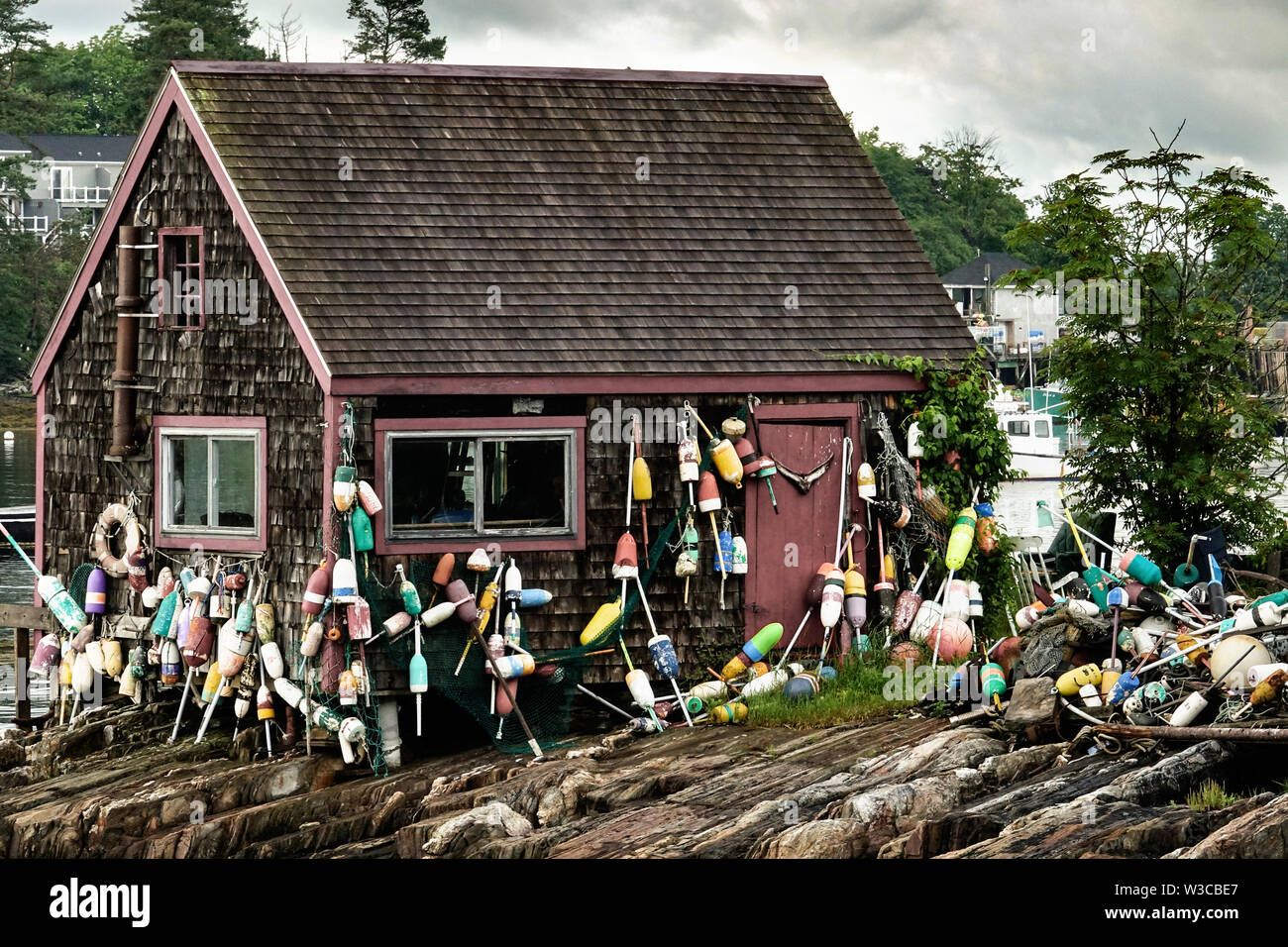 Historic Bailey Fish House covered in lobster buoys along Mackerel Cove