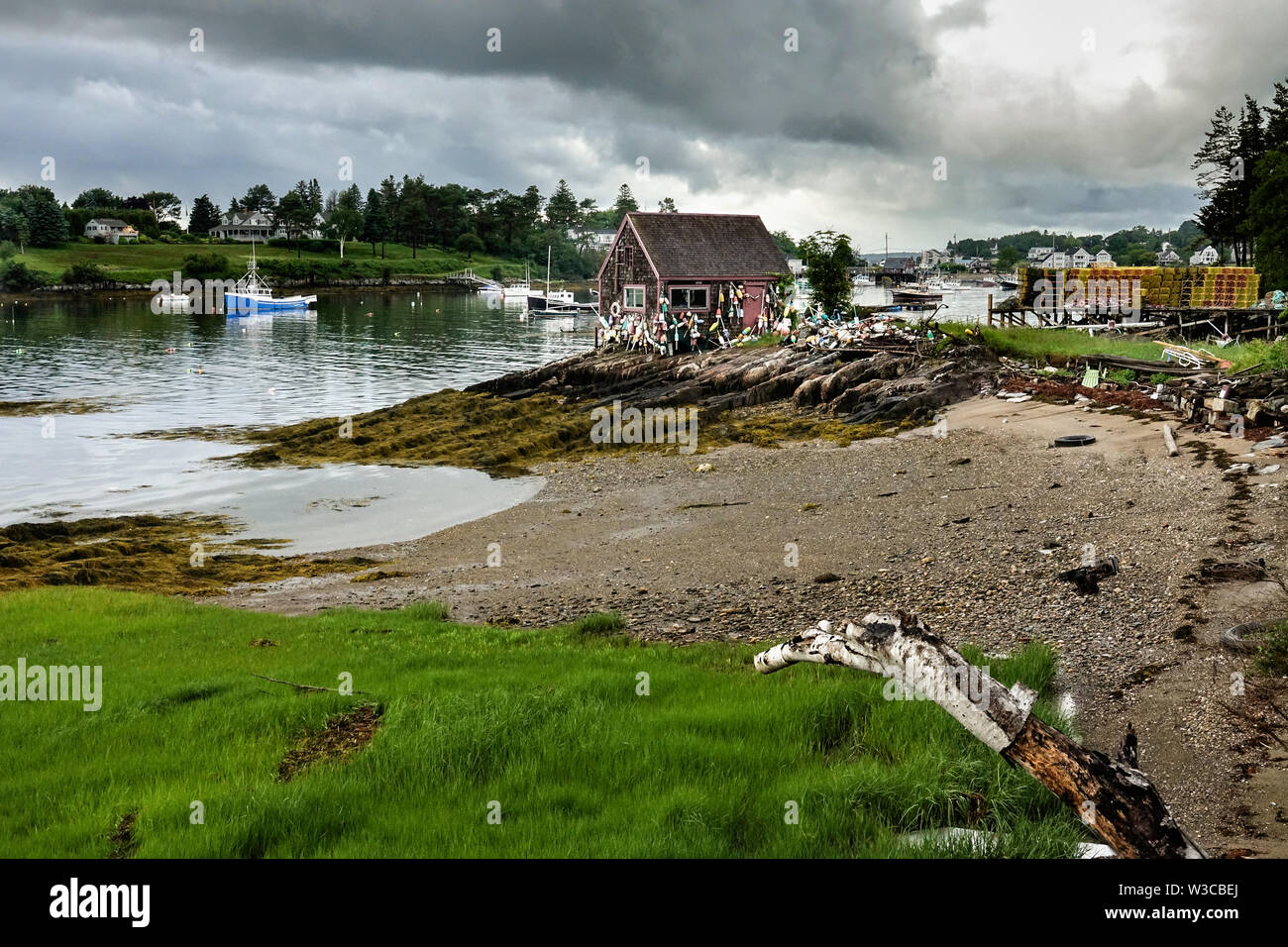 Historic Bailey Fish House covered in lobster buoys along Mackerel Cove