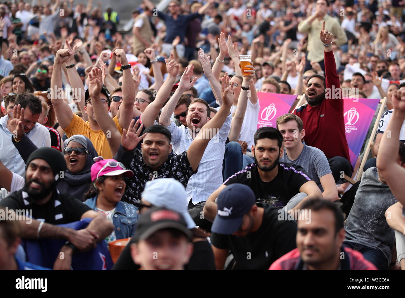 England and New Zealand fans react as they watch a big screen in the