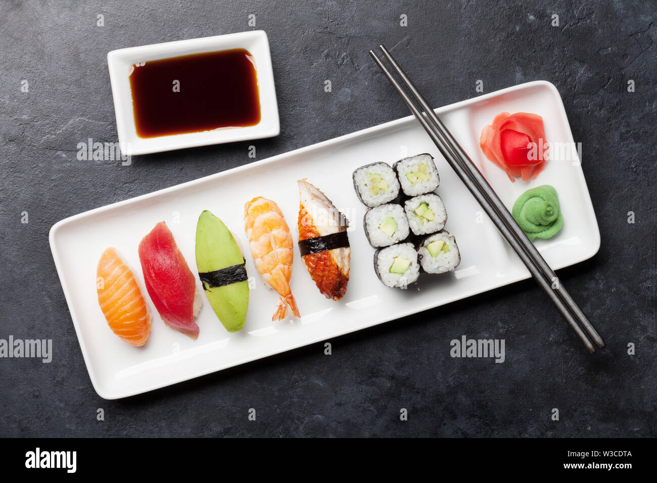 Japanese Sushi Set. Sashimi, Maki Rolls. On Plate Over Stone