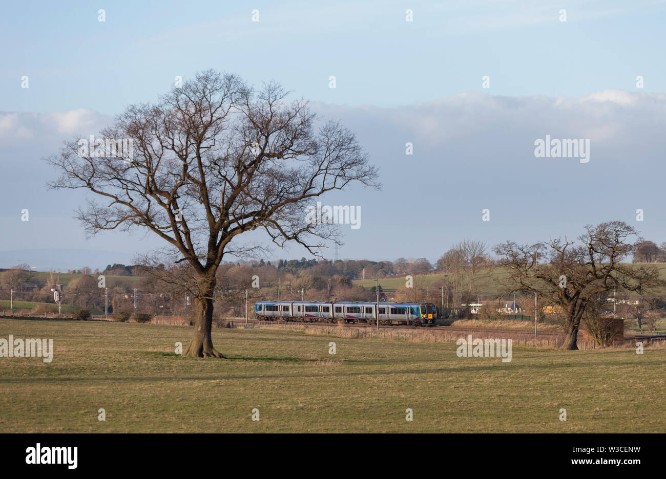 First Transpennine Express class 350 elcectric train passing Brisco (South of Carlisle) on the WCML with a Glasgow Central - Manchester Airport train Stock Photo