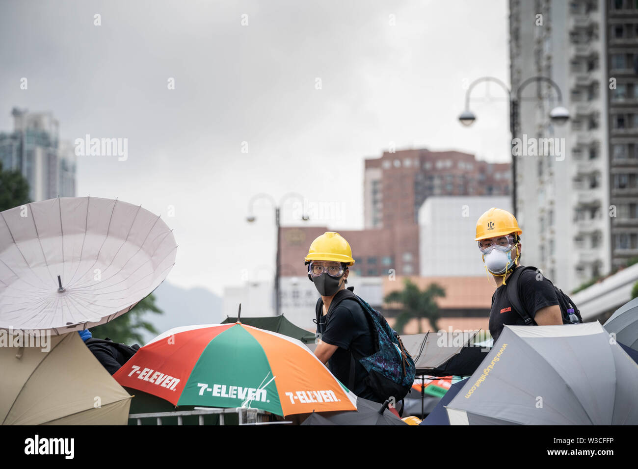 Two demonstrators seen at the front line during the stand off with the police.Thousands of pro democracy demonstrators took to the street once again in a new wave of anti government demonstrations which sparked by the extradition bill that the Hong Kong government was trying to push forward in June 2019.Police has made at least 30 arrests as protesters clashed with the riot police in the evening. Stock Photo