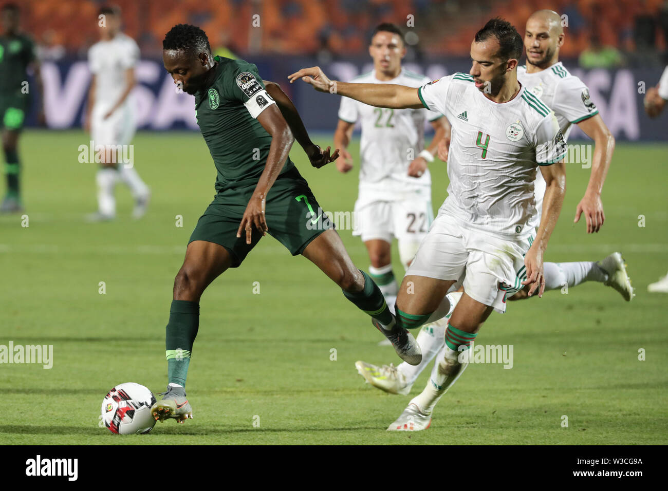Cairo, Egypt. 14th July, 2019. Algeria's Djamel Benlamri (R) and Nigeria's Ahmed Musa battle for the ball during the 2019 Africa Cup of Nations semi-final soccer match between Algeria and Nigeria at the Cairo International Stadium. Credit: Oliver Weiken/dpa/Alamy Live News Stock Photo