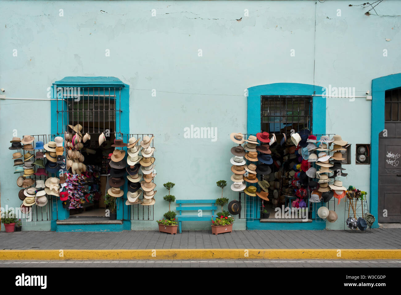 Building facade with souvenir shop displaying hats in downtown Cholula, near Puebla, Mexico. Jun 2019 Stock Photo