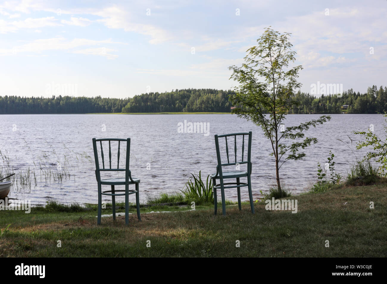 Two chairs by the lake Ainesjärvi in Ylöjärvi, Finland Stock Photo
