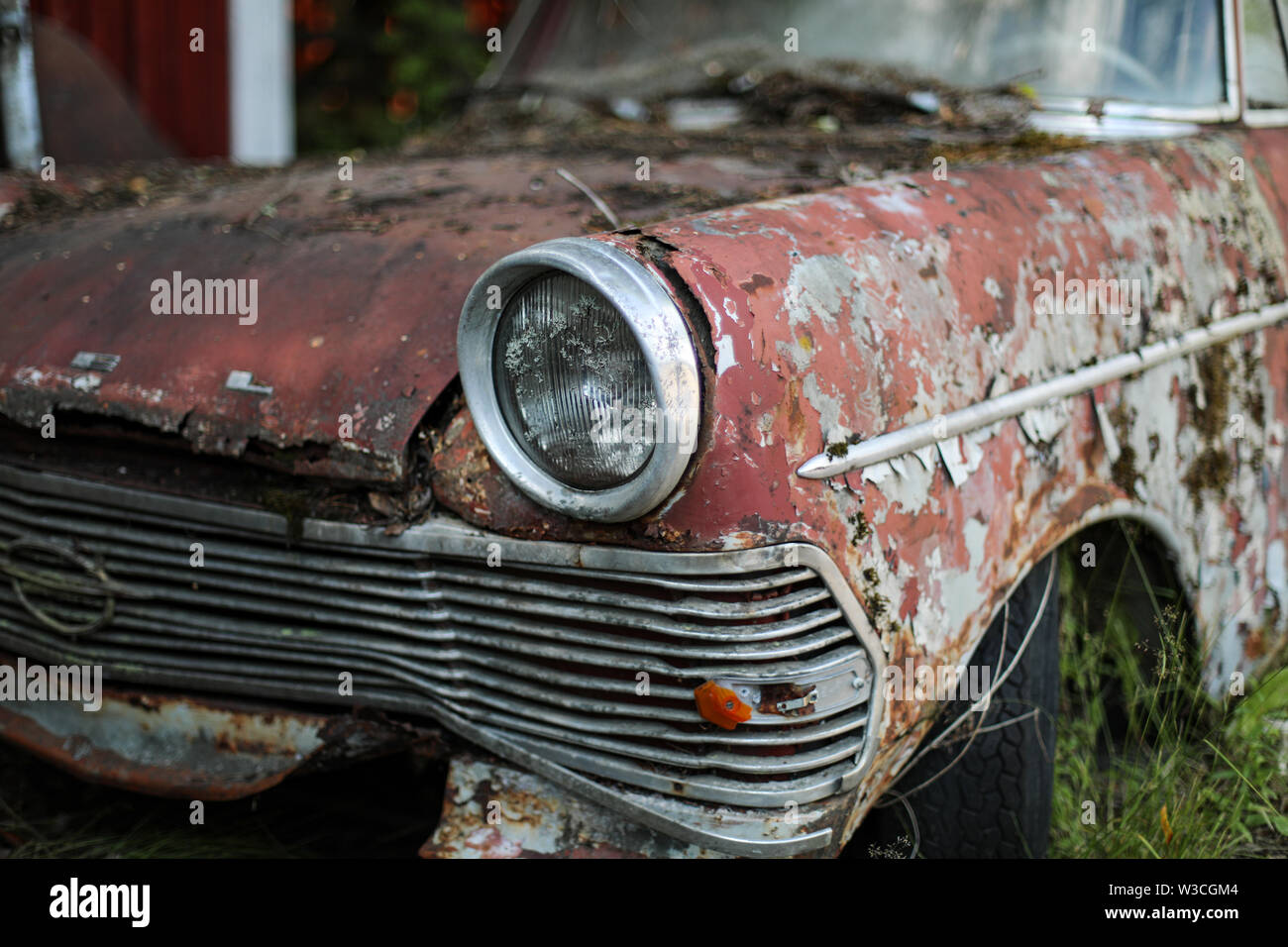 Old Opel headlamp at car junkyard in Ylöjärvi, rural Finland Stock Photo