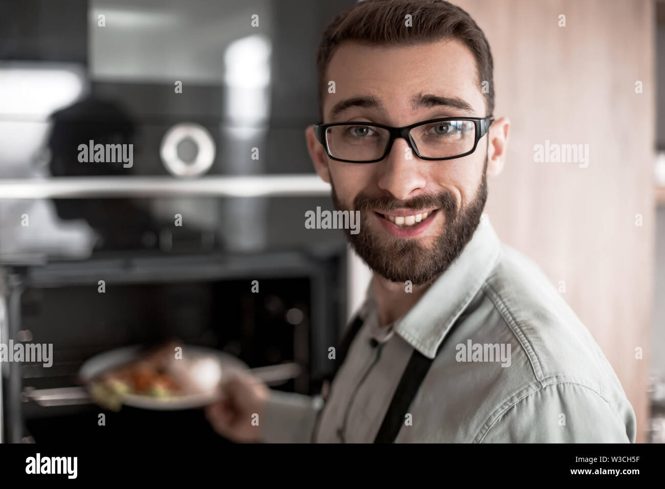friendly man inviting to Breakfast in his kitchen Stock Photo