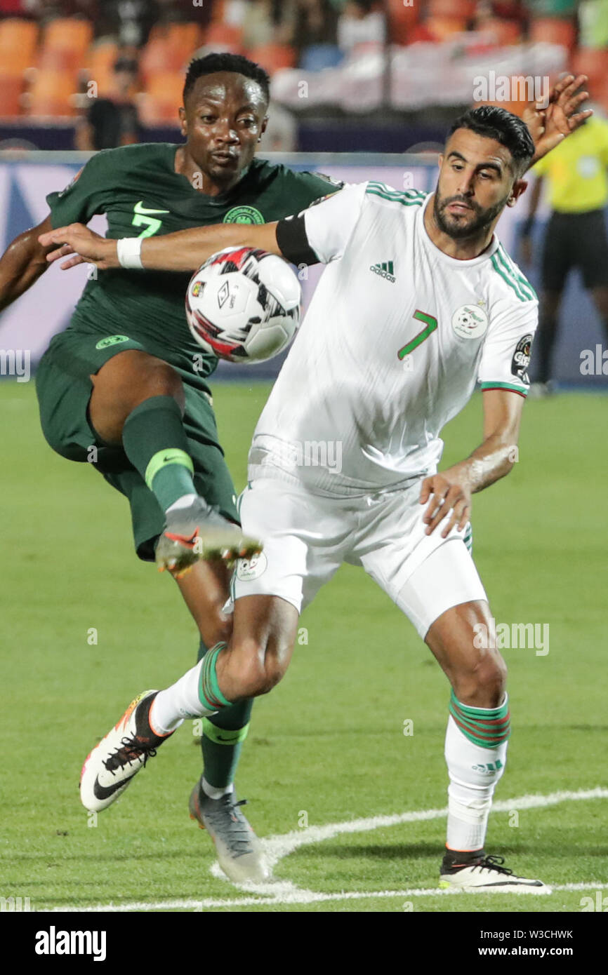 Cairo, Egypt. 14th July, 2019. Algeria's Riyad Mahrez (R) and Nigeria's Ahmed Musa battle for the ball during the 2019 Africa Cup of Nations semi-final soccer match between Algeria and Nigeria at the Cairo International Stadium. Credit: Oliver Weiken/dpa/Alamy Live News Stock Photo