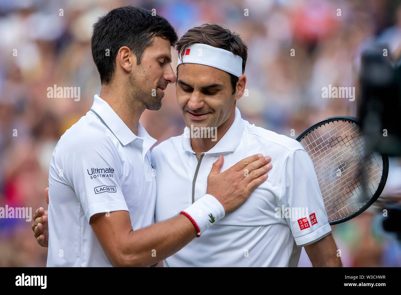 London, UK. 14th July 2019, The All England Lawn Tennis and Croquet Club,  Wimbledon, England, Wimbledon Tennis Tournament, Day 13, mens singles  final; Novak Djokovic (SER) speaks with Roger Federer (SUI) after