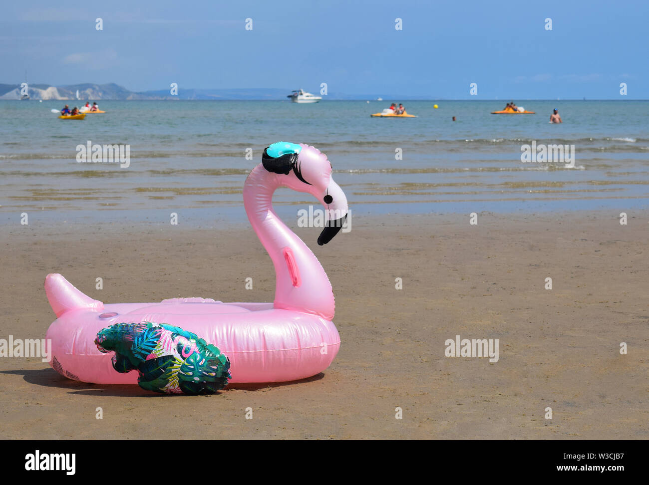 Pink Inflatable Flamingo on Weymouth Beach UK Stock Photo