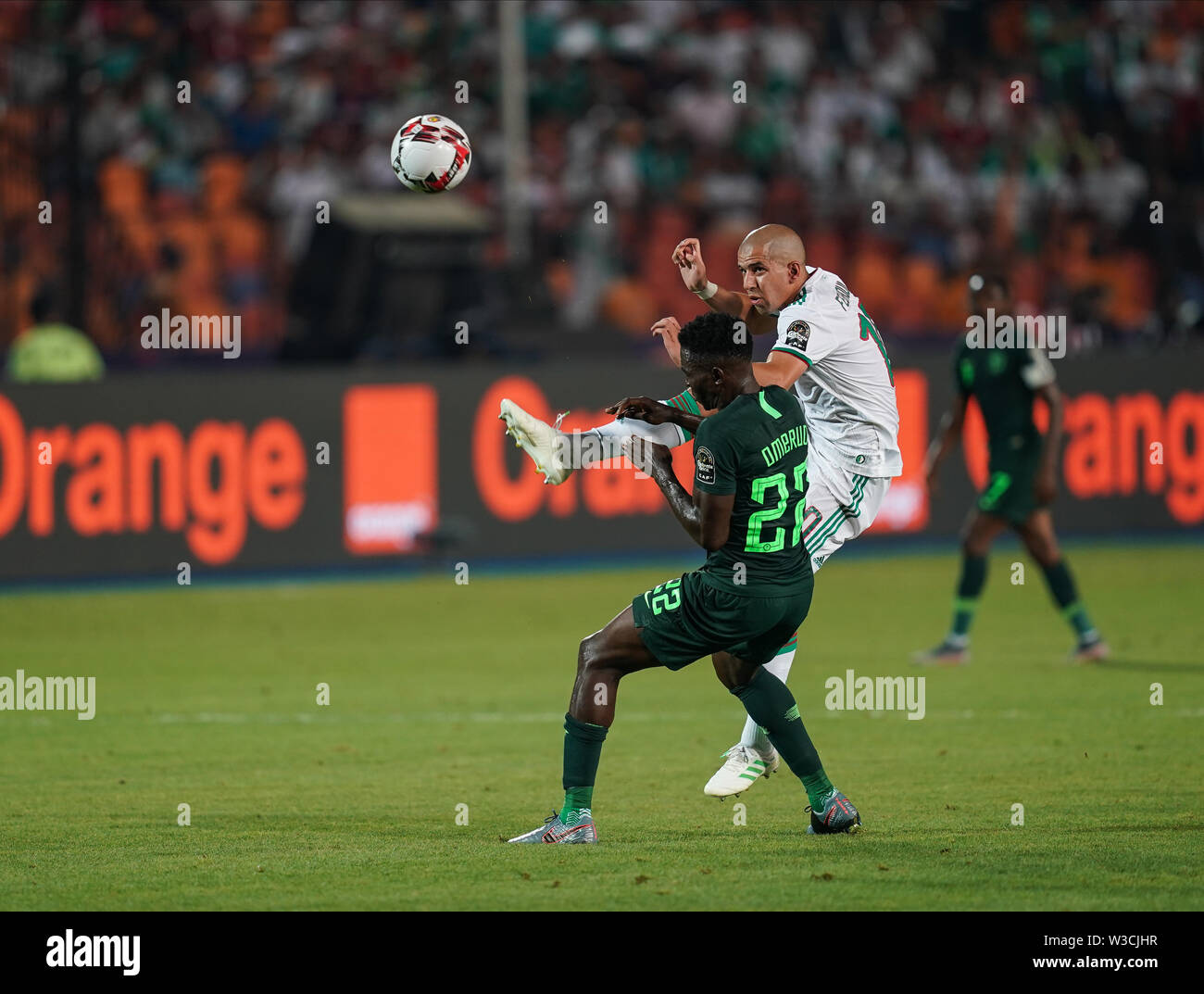 Cairo, Algeria, Egypt. 14th July, 2019. FRANCE OUT July 14, 2019: Sofiane Feghouli of Algeria passing the ball in front of Kenneth Josiah omeruo of Nigeria during the 2019 African Cup of Nations match between Algeria and Nigeria at the Cairo International Stadium in Cairo, Egypt. Ulrik Pedersen/CSM/Alamy Live News Stock Photo