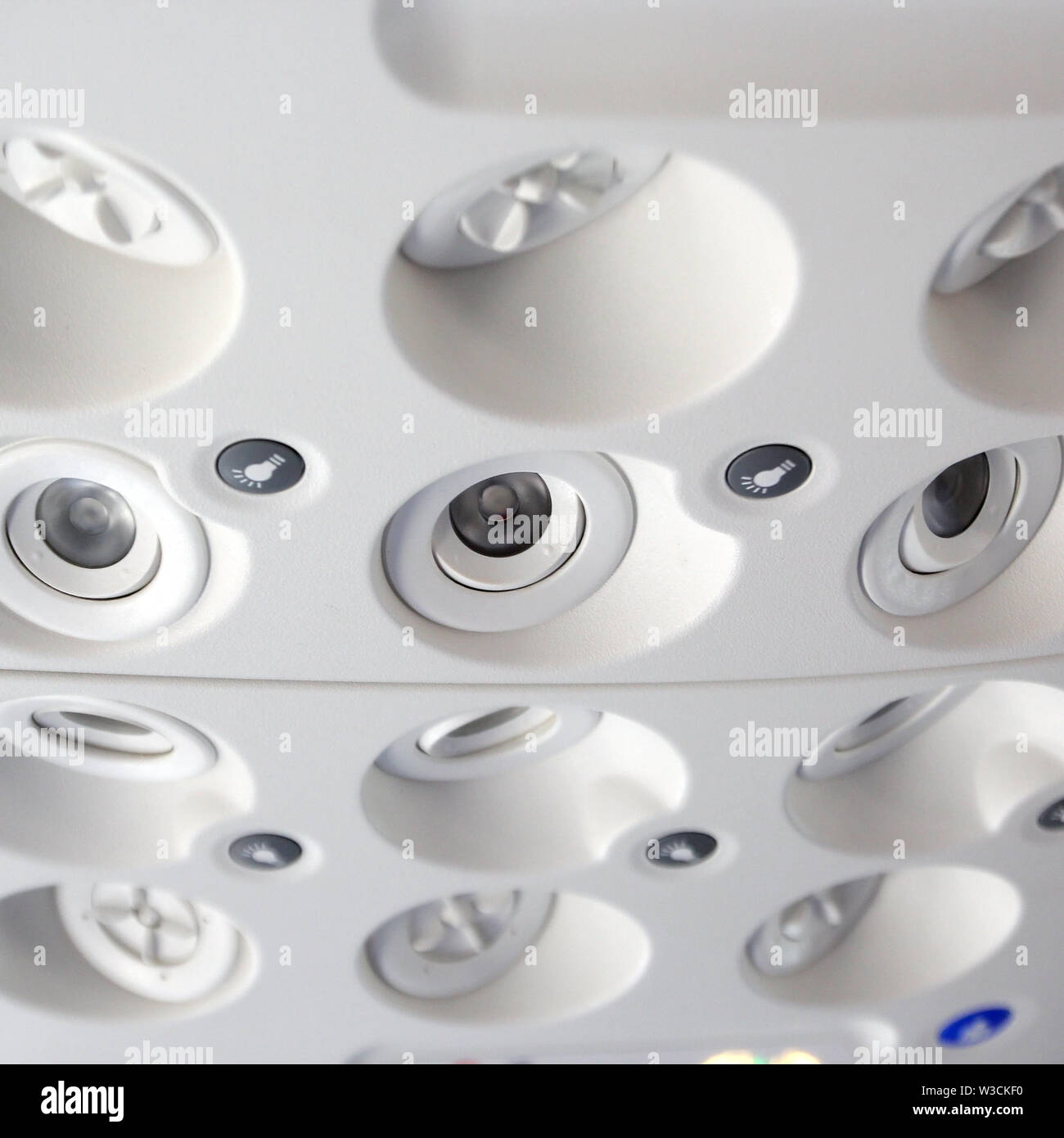 Closeup Of Air Grille Diffuser And Lamp On Ceiling In The Airplane