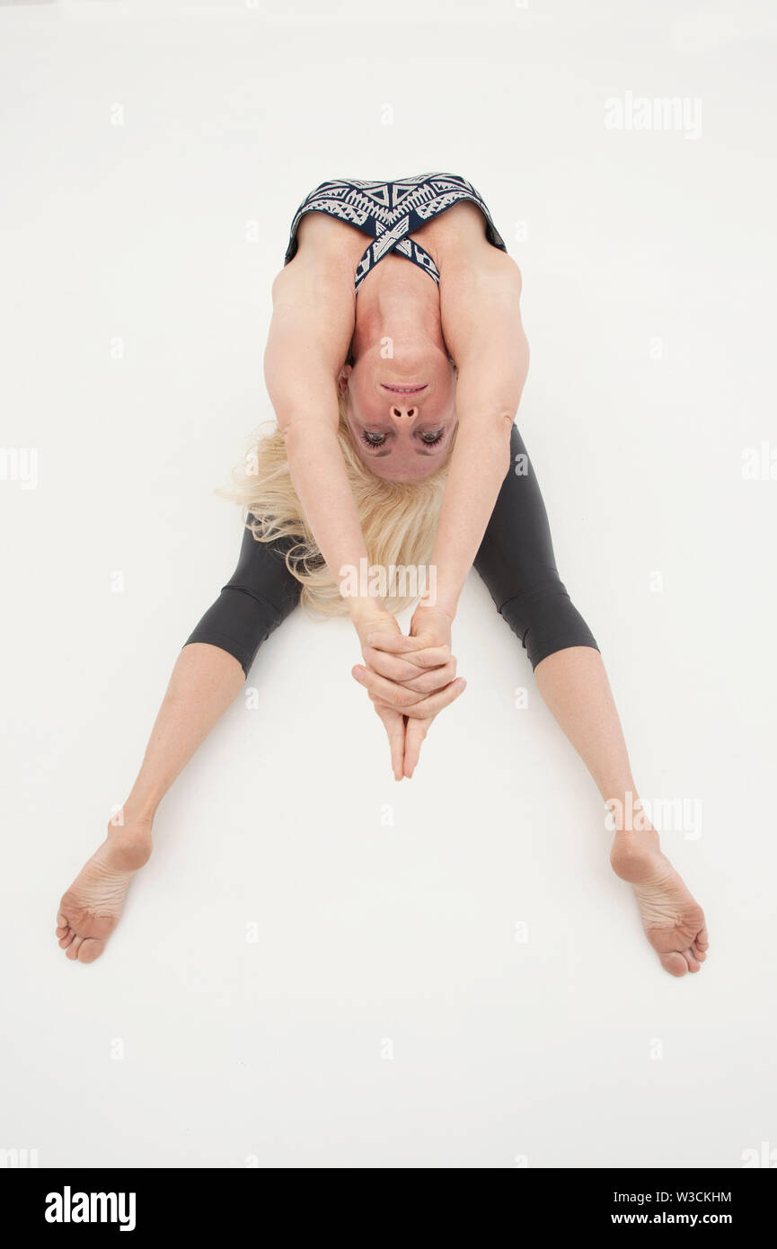 Advanced Yoga Practitioner Woman in Extreme Yoga Pose Stock Photo