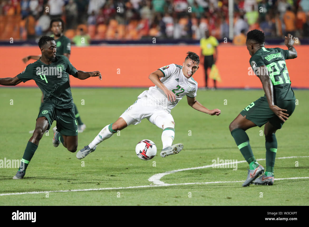 Cairo, Egypt. 14th July, 2019. Algeria's Ismael Bennacer (C) battles for the ball with Nigeria's Wilfred Ndidi (L) and Kenneth Omeruo during the 2019 Africa Cup of Nations semi-final soccer match between Algeria and Nigeria at the Cairo International Stadium. Credit: Oliver Weiken/dpa/Alamy Live News Stock Photo