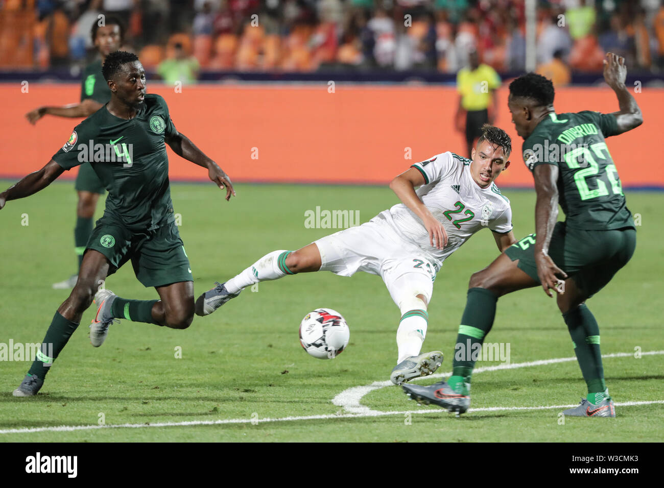 Cairo, Egypt. 14th July, 2019. Algeria's Ismael Bennacer (C) battles for the ball with Nigeria's Wilfred Ndidi (L) and Kenneth Omeruo during the 2019 Africa Cup of Nations semi-final soccer match between Algeria and Nigeria at the Cairo International Stadium. Credit: Oliver Weiken/dpa/Alamy Live News Stock Photo