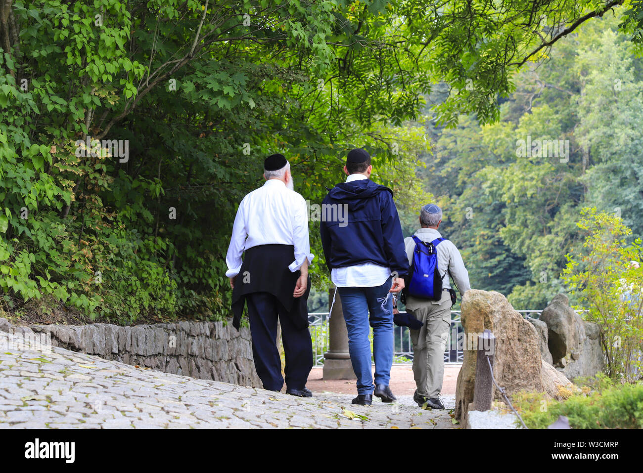 Older Hasidic Jews walk in the park during the Jewish New Year in Uman, Ukraine. Religious Jew. Stock Photo