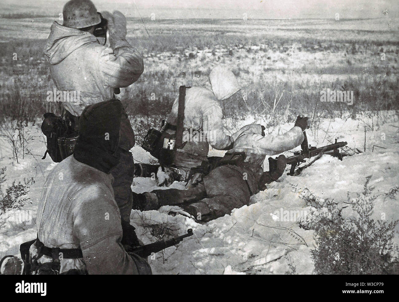 German Soldiers in White Winter Camouflage load an MG42 Machine Gun on the Russian Front 1943 Stock Photo