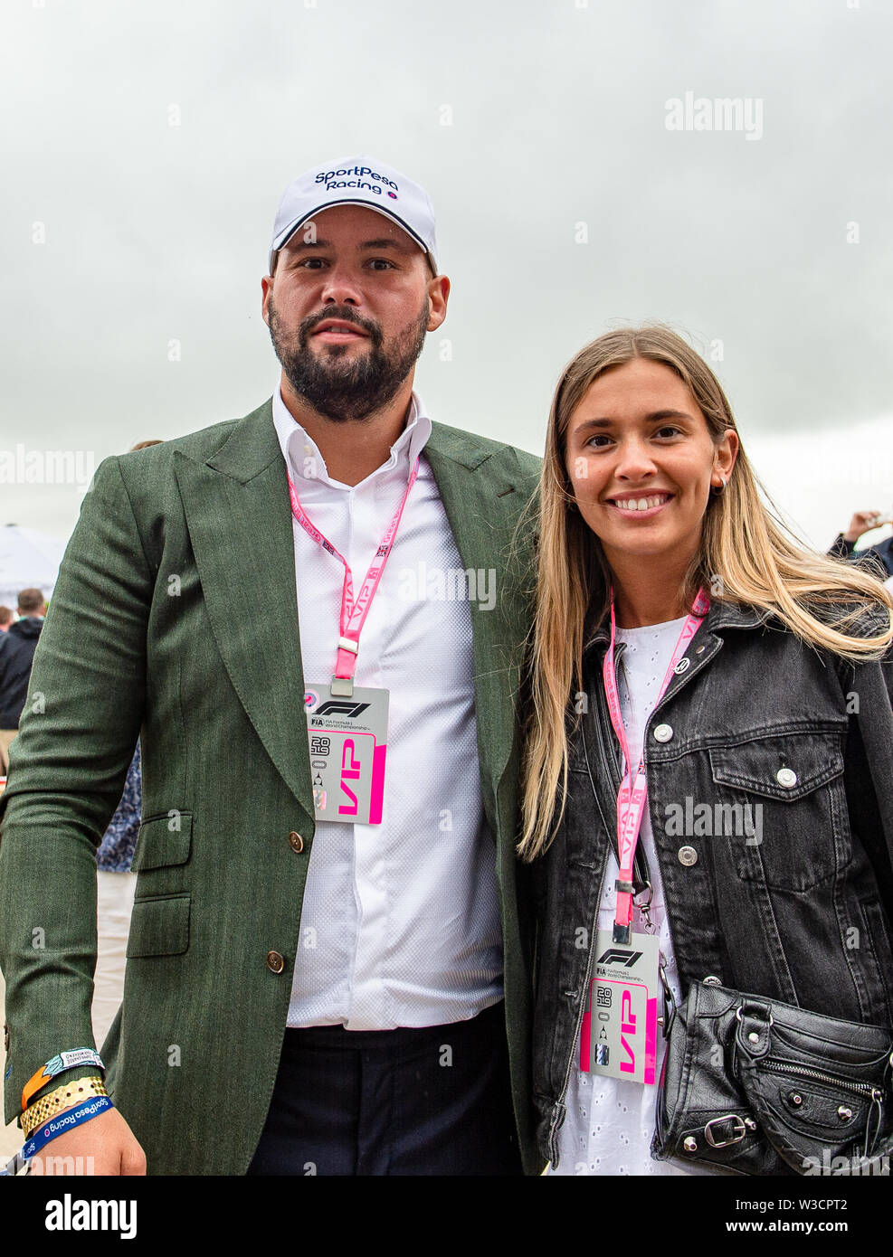 Towcester, United Kingdom. 14th July, 2019. Tony Bellew - Former professional boxer and commentator (left) takes selfie with his fan during Race Day of Formula 1 Rolex British Grand Prix 2019 at Silverstone Circuit on Sunday, July 14, 2019 in Towcester, ENGLAND. Credit: Taka G Wu/Alamy Live News Stock Photo