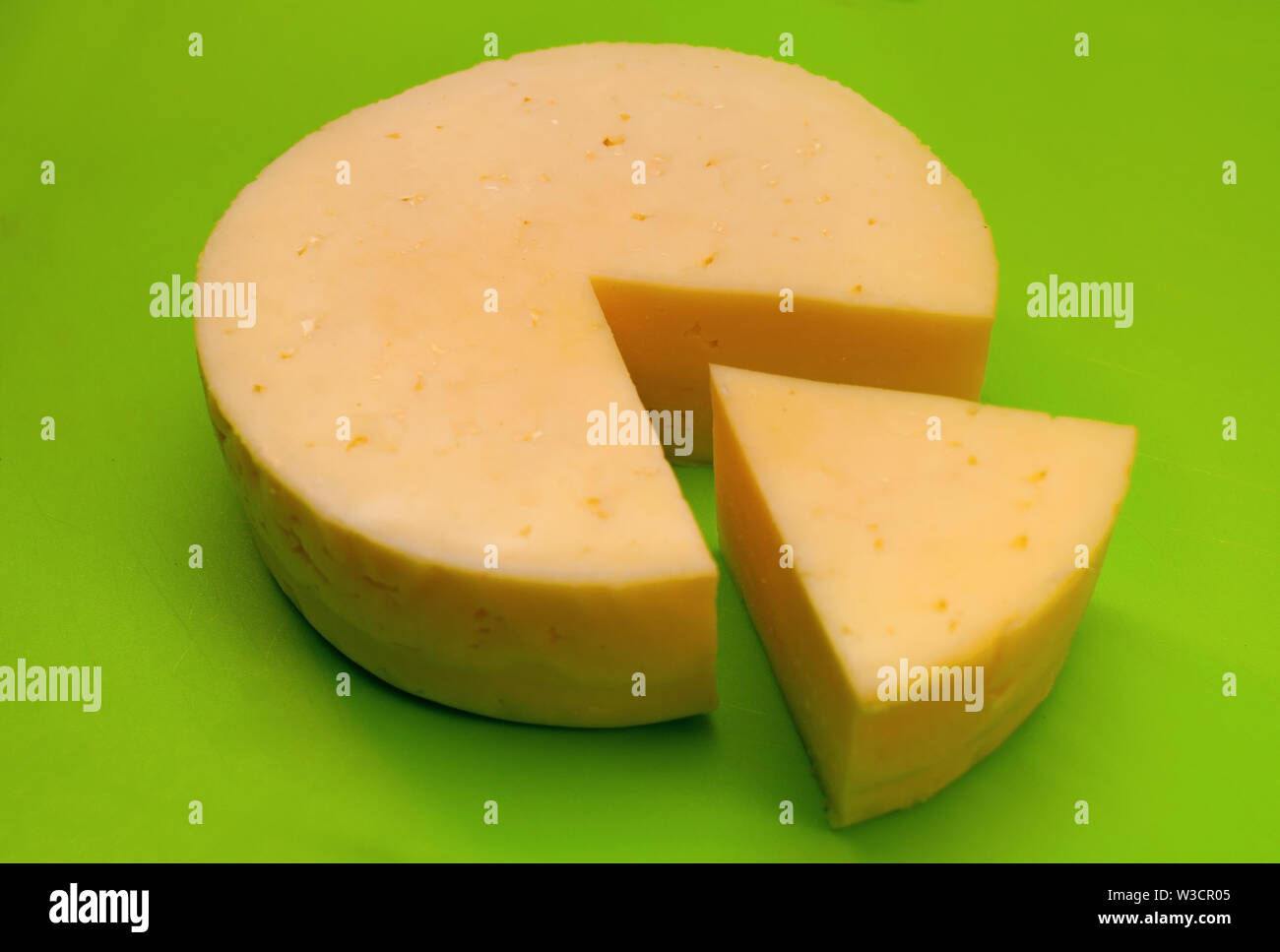 Round hard cheese on a cutting board Stock Photo Alamy