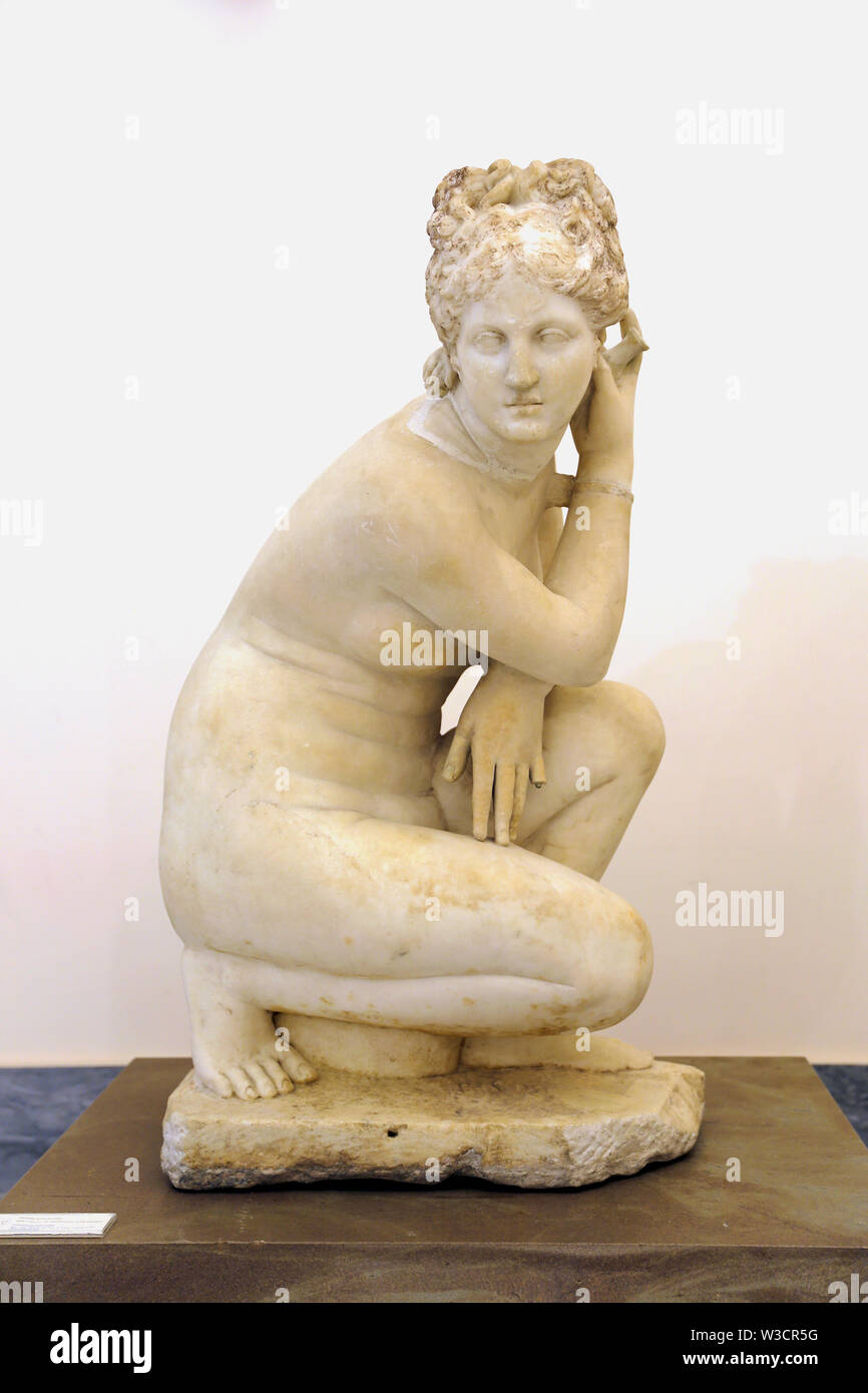 Crouching Aphrodite. sculpture (2nd. century AD) copy from a Greek original of the Hellenistic period. Marble. Archaeological Museum. Stock Photo