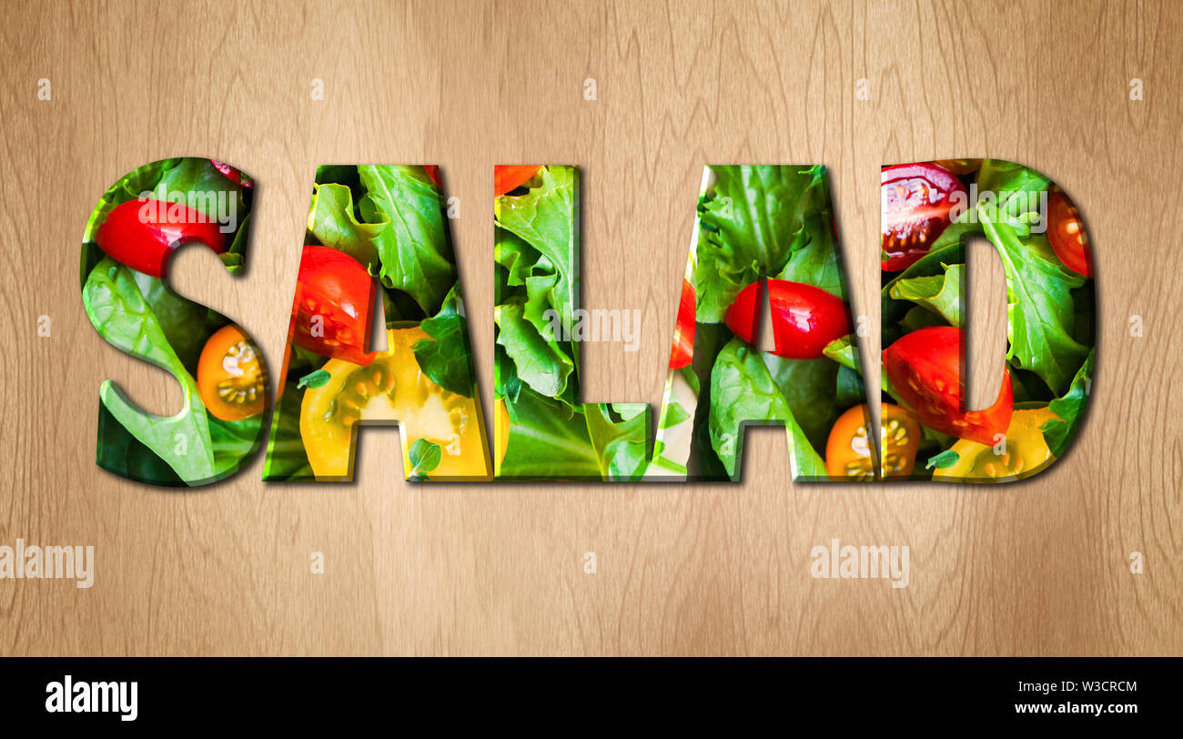 Salad word covered with various vegetables on a kitchen cutting board Stock Photo