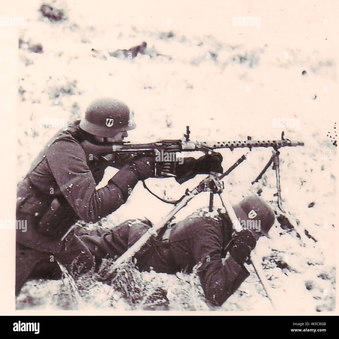SS Troops fire Light MG34 in winter snow on the Russian Front 1941 Stock Photo