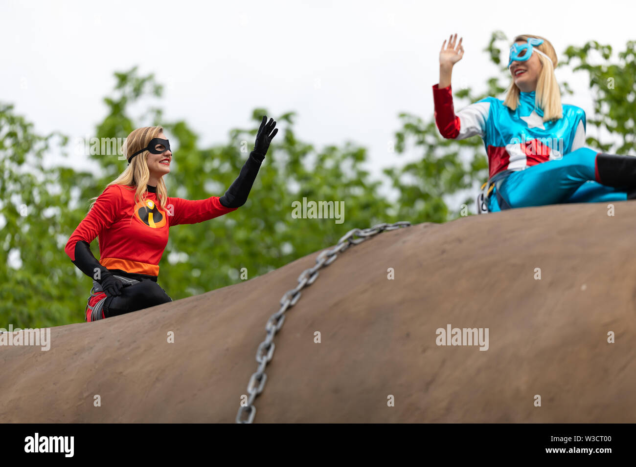 Louisville, Kentucky, USA - May 2, 2019: The Pegasus Parade, Women dress up as superheroes, riding on top of a giant potato during the parade Stock Photo