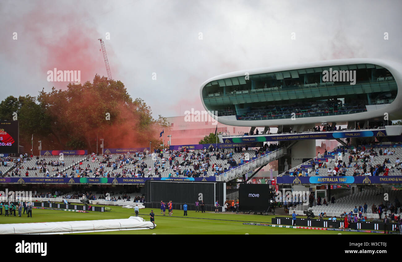 London, UK. 14th July, 2019. Red smoke coming from the nursery ground behind the media centre, denoting a landing zone for the Red Devils parachute display team. during the New Zealand v England, ICC Cricket World Cup Final match, at Lords, London, England. Credit: ESPA/Alamy Live News Stock Photo