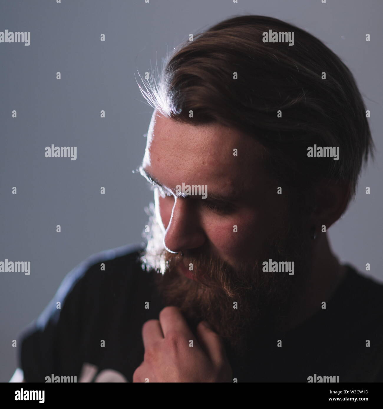 close up. portrait of a brooding bearded man . isolated on dark ...