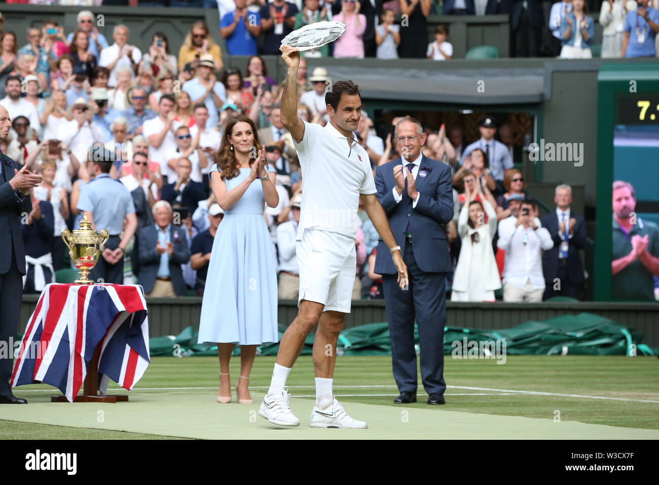 Wimbledon, London, UK. 14th July 2019. Roger Federer of Switzerland waves  to the fans during the trophy ceremony after the men's singles final match  of the Wimbledon Lawn Tennis Championships against Novak