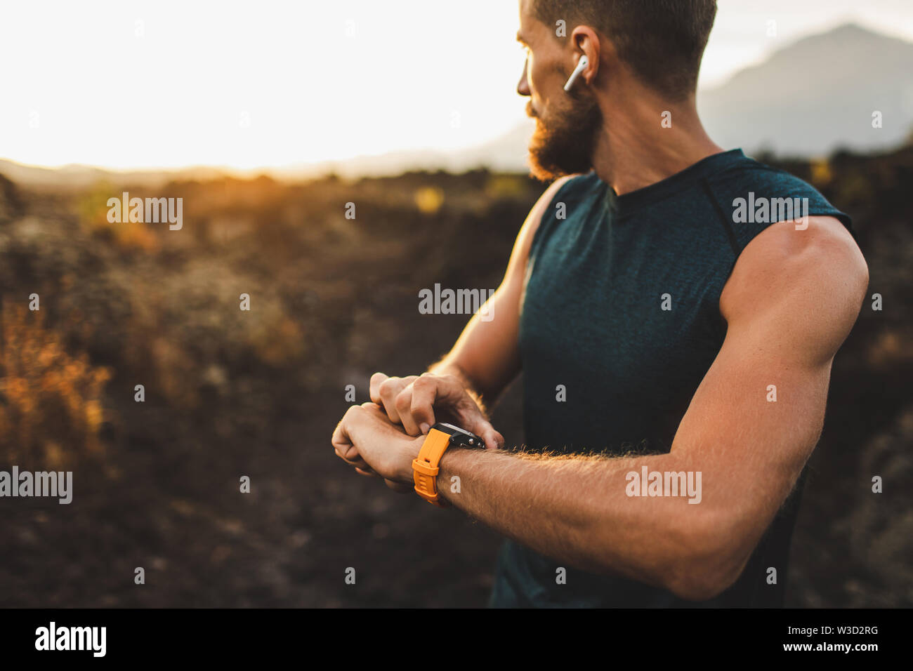 Athletic runner start training on fitness tracker or smart watch and