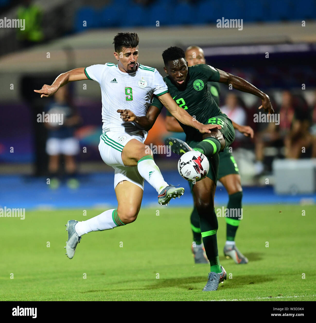 Cairo. 14th July, 2019. Baghdad Bounedjah (L) of Algeria vies with Kenneth Omeruo of Nigeria during the semifinal match between Algeria and Nigeria at the 2019 Africa Cup of Nations in Cairo, Egypt on July 14, 2019. Credit: Wu Huiwo/Xinhua/Alamy Live News Stock Photo