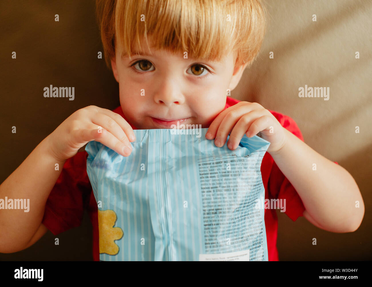 Cute child with pack of chips Stock Photo