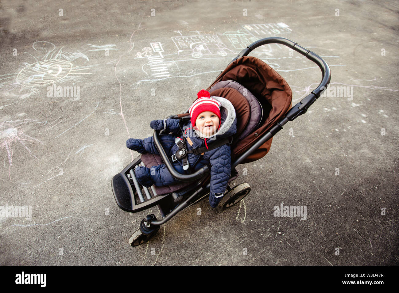 Cute baby in stroller on street Stock Photo