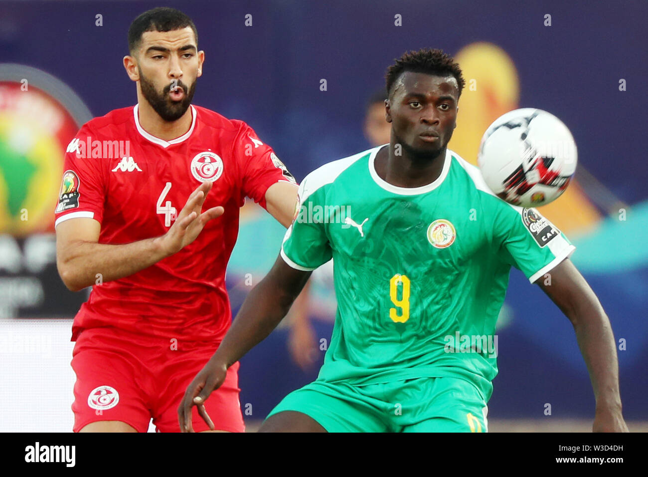 Cairo. 14th July, 2019. Senegal's Mbaye Niang (R) vies with Tunisia's Yassine Meriah during the semifinal match at the 2019 Africa Cup of Nations in Cairo, Egypt on July 14, 2019. Senegal won 1-0 and advanced to the final. Credit: Ahmed Gomaa/Xinhua/Alamy Live News Stock Photo