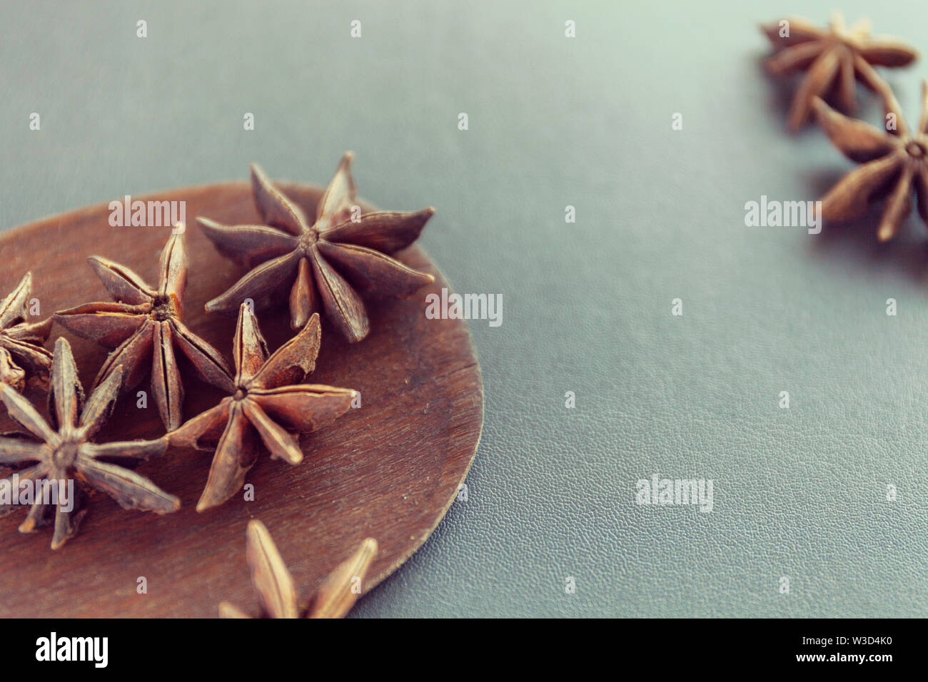 Dry Star anise on a brown wooden spatula. Natural food spices and seasonings. Tasty eating. Close-up. Stock Photo