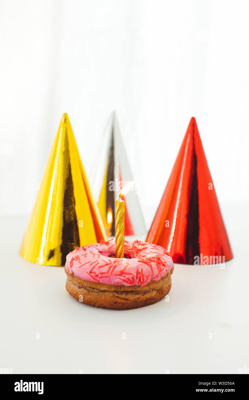 One candle with fire in a donut Stock Photo