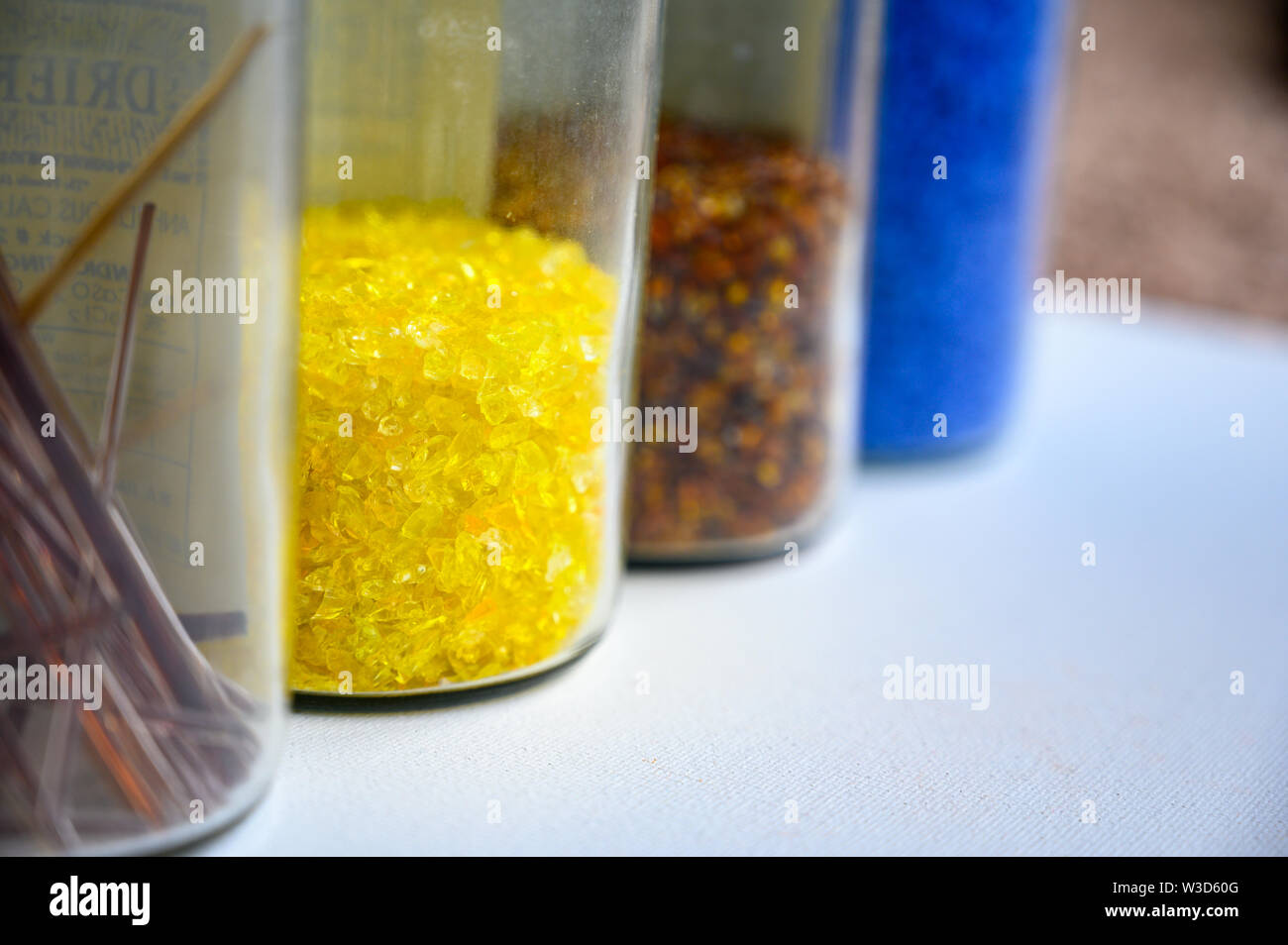 Jars of pulled cane and frit glass blowing supplies Stock Photo - Alamy