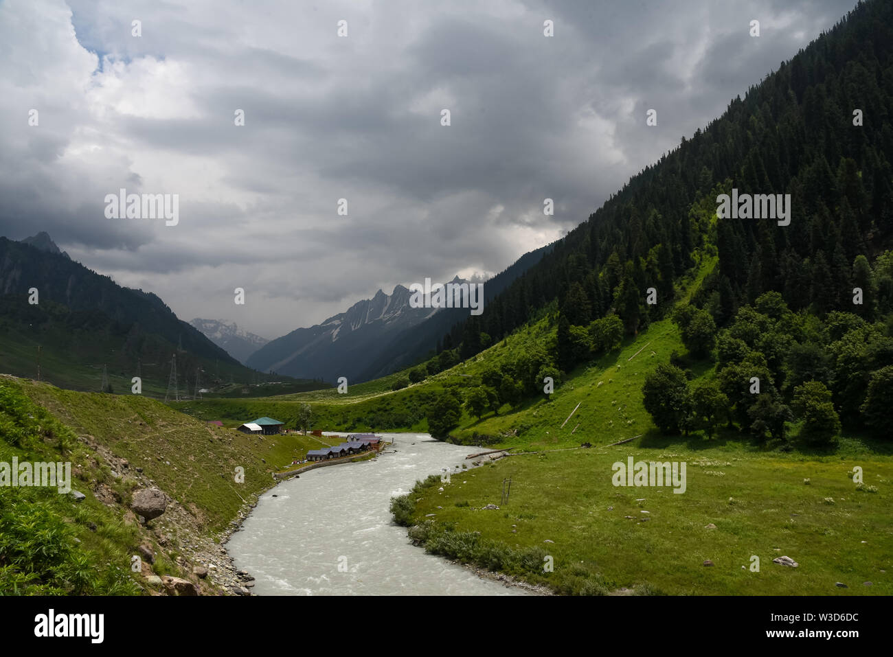 Ganderbal, India. 13th July, 2019. River Sindh flowers under the foothill of Himalayan mountains during a cloudy evening in Sonamarg, some 85kms from summer capital Srinagar.Jammu and Kashmir is a disputed territory divided between India and Pakistan but claimed in its entirety by both sides. Credit: SOPA Images Limited/Alamy Live News Stock Photo