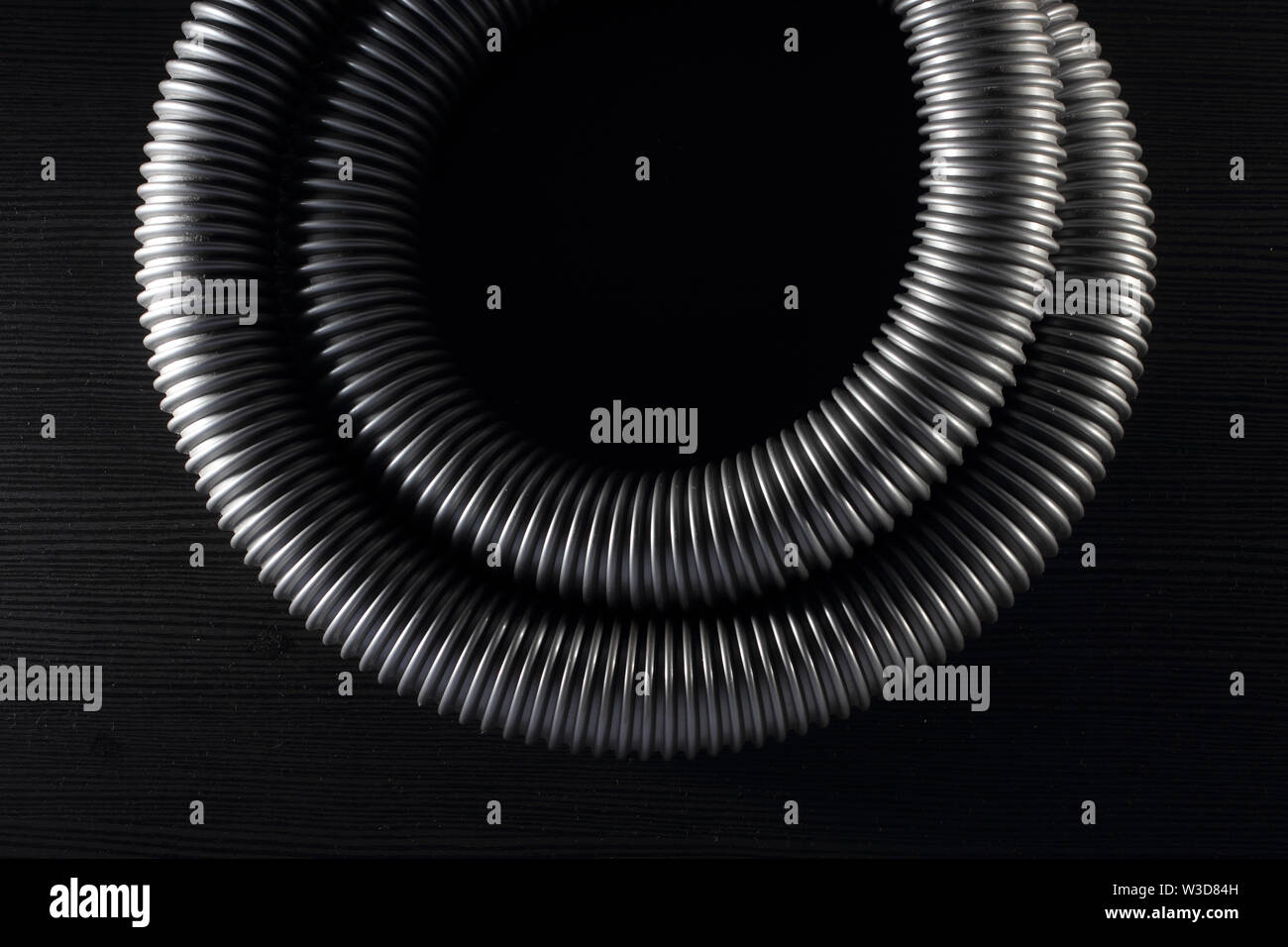 Vacuum Hose on Black Background Stock Photo