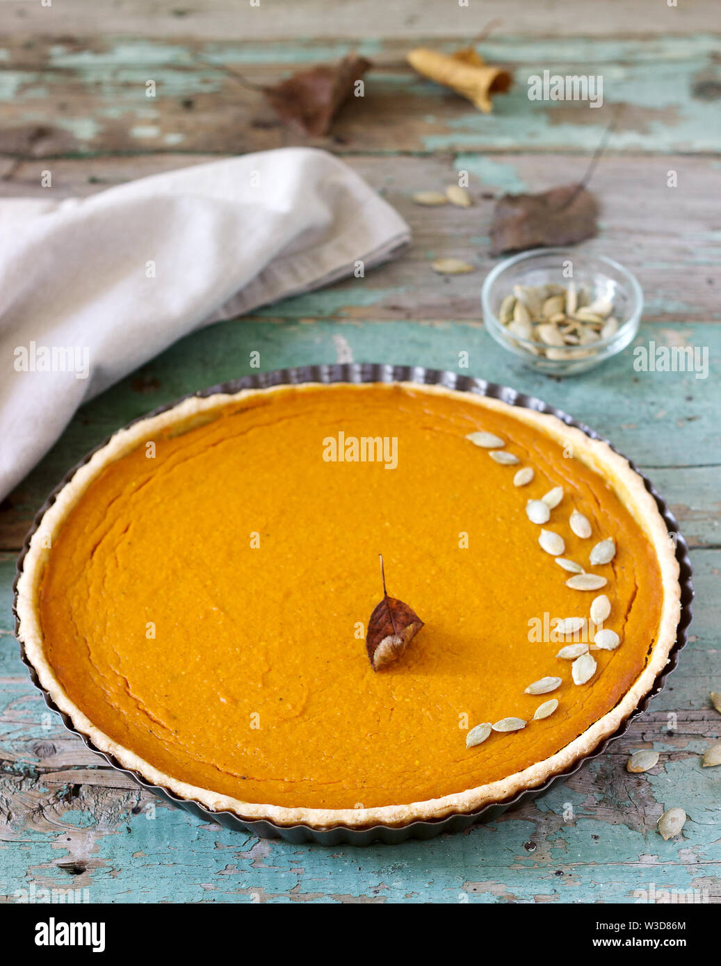 Traditional American pumpkin pie for Thanksgiving Day or Halloween on a wooden background. Rustic style. Stock Photo