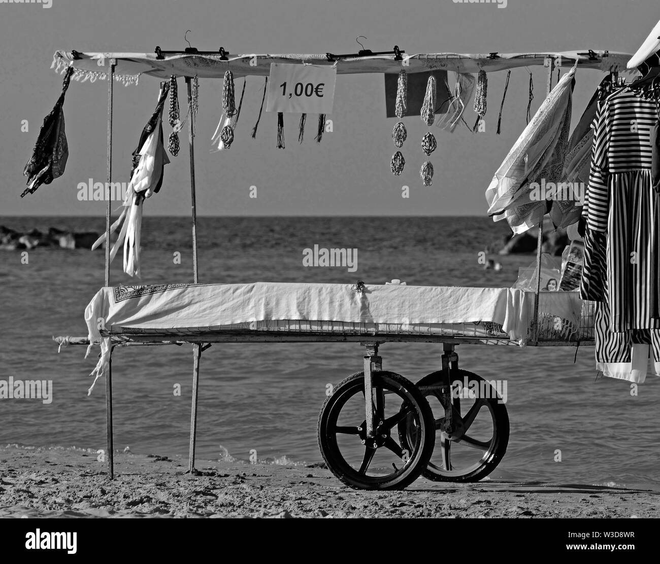 shopping handcart beach with clothes and gifts on the shore of Adriatic sea Stock Photo
